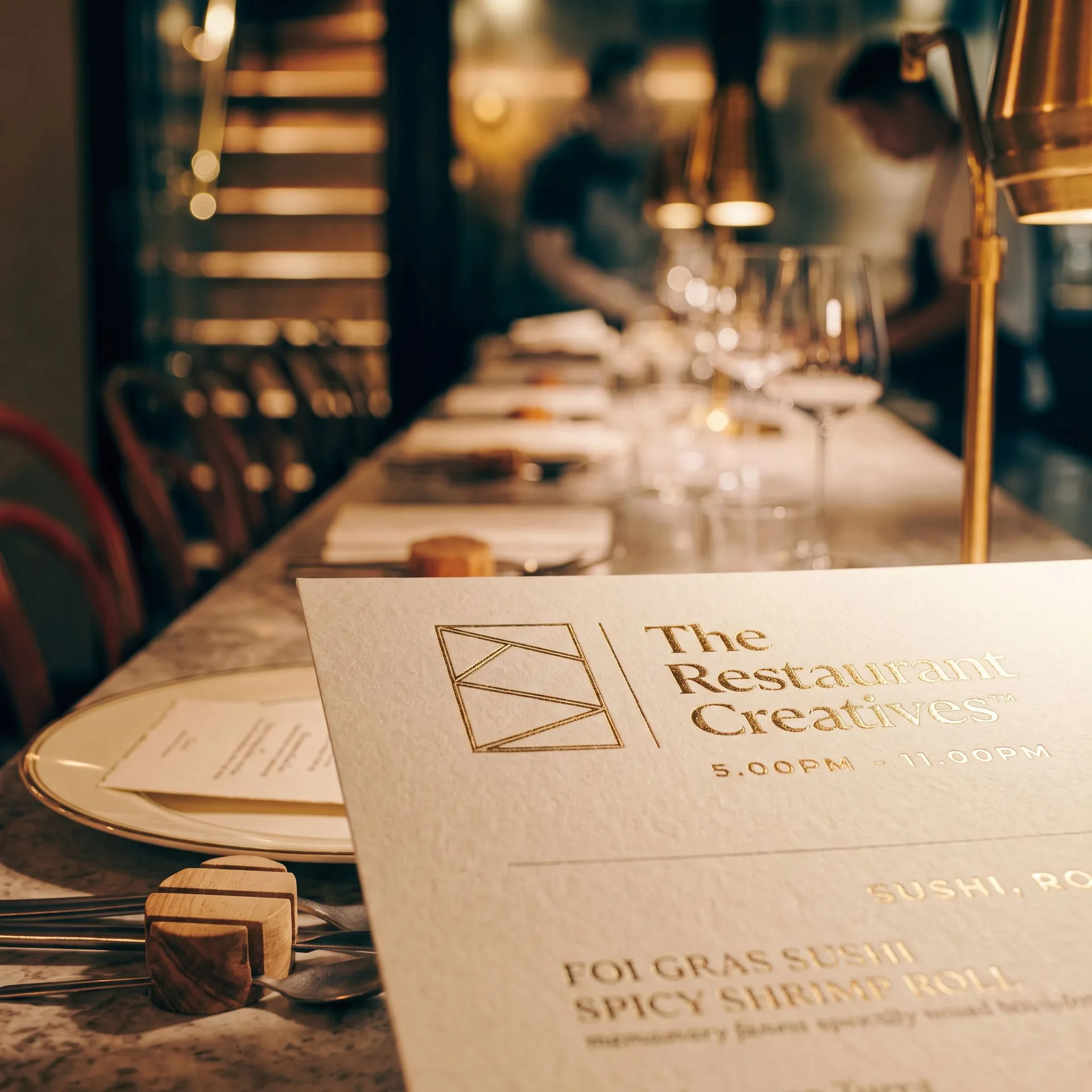 Restaurant table with menu and dining room in the background